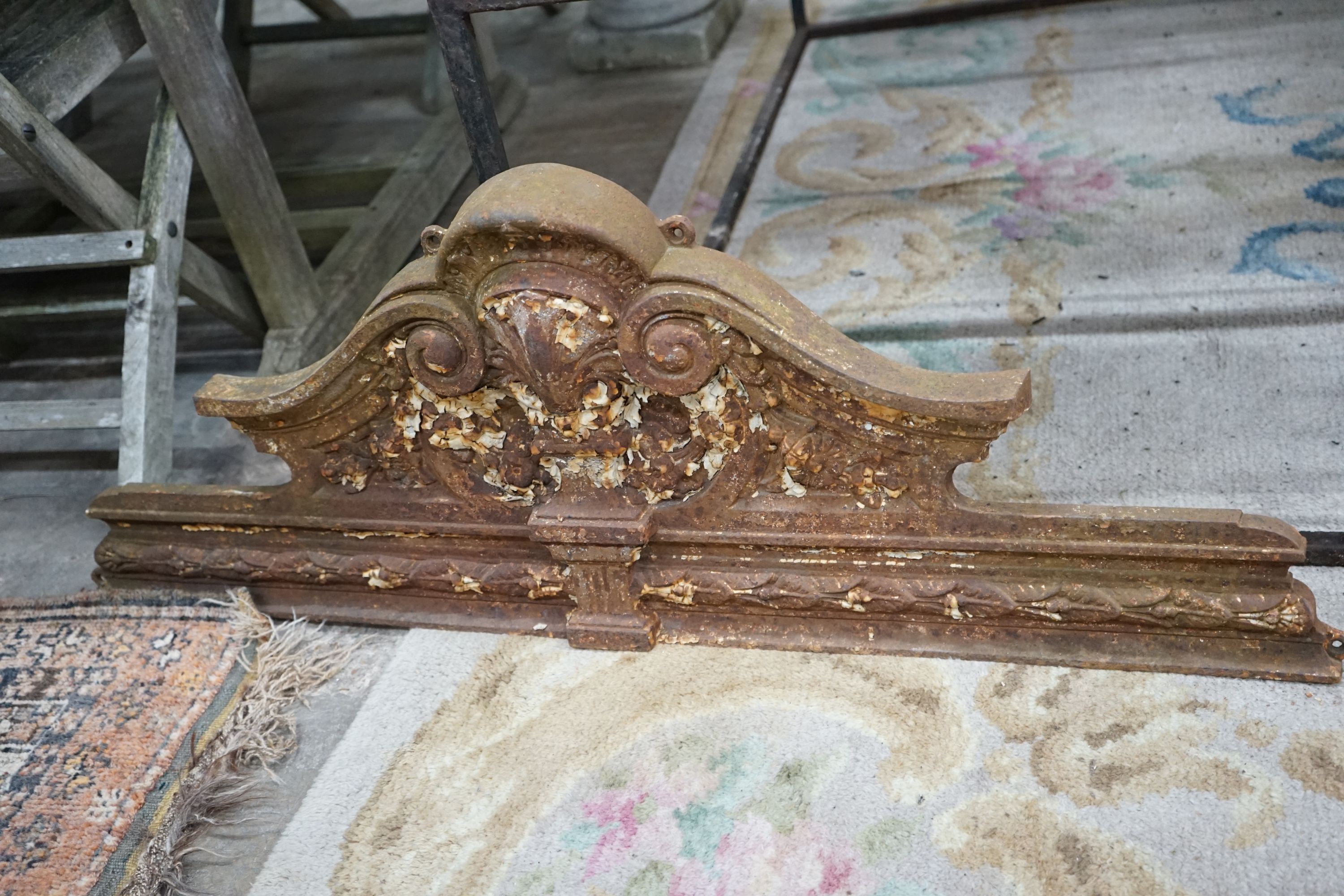 A pair of Victorian cast iron shell and scroll door pediments, each width 108cm, height 38cm